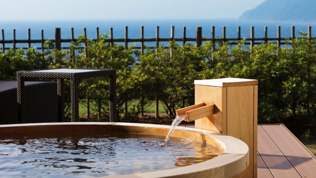 a water fountain in the middle of a pool at Fugaku Gunjo in Izu