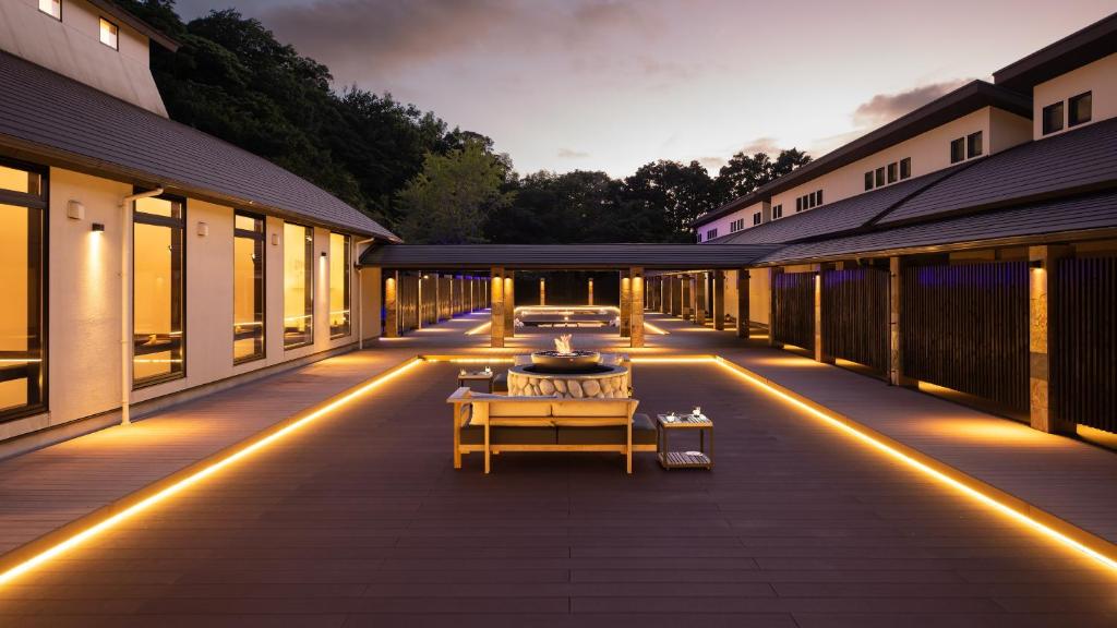 a patio with lights on the side of a building at Fugaku Gunjo in Izu