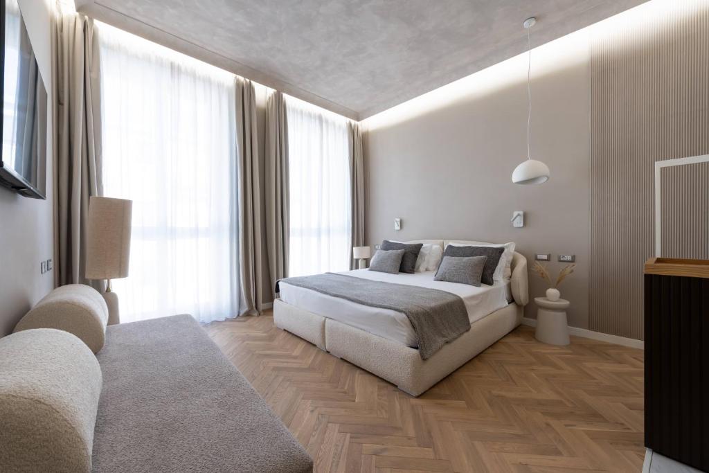 a bedroom with a bed and a large window at Duomo Collection in Milan