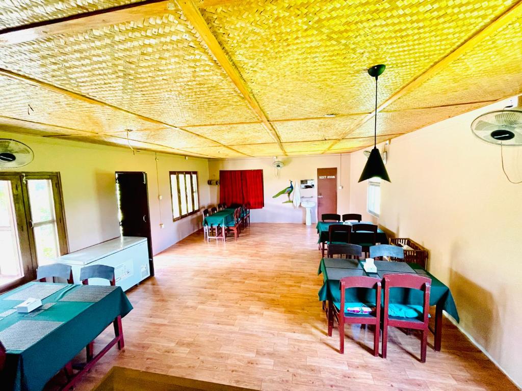 a room with tables and chairs in a room at Hotel Tree Tops- A Serene Friendly Hotel in Sauraha in Chitwan