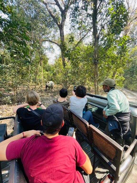 a group of people riding in the back of a truck at Hotel Tree Tops- A Serene Friendly Hotel in Sauraha in Chitwan