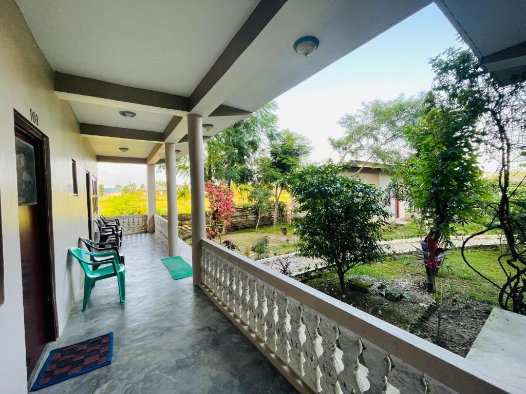 a balcony with a view of a yard at Hotel Tree Tops- A Serene Friendly Hotel in Sauraha in Chitwan