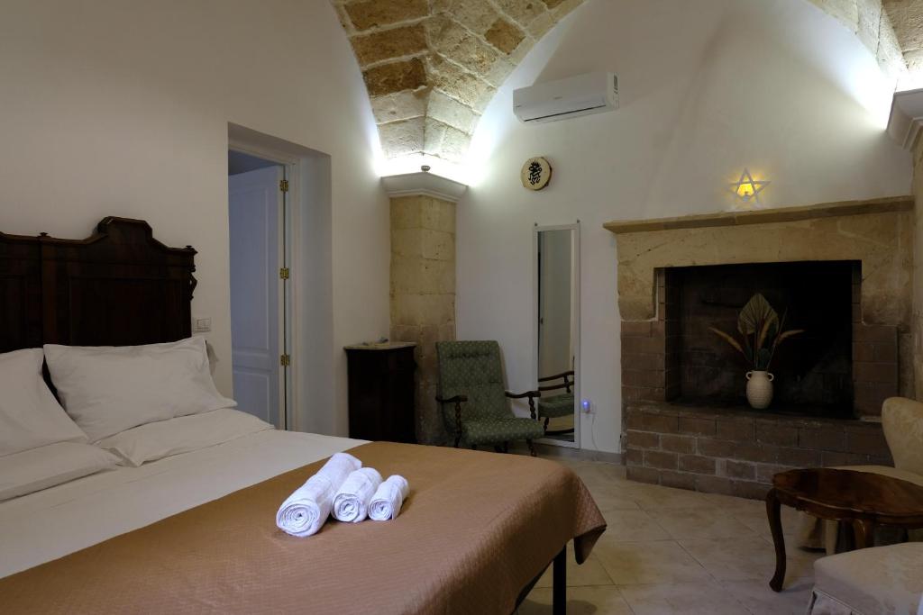 a bedroom with a bed with two slippers on it at Memoir Appartamento Lecce in Lecce