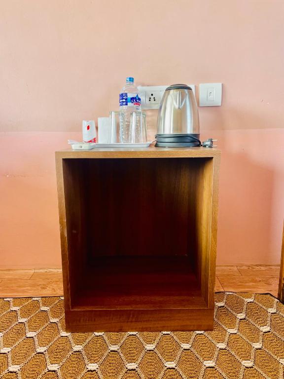 a table with a tea kettle on top of it at Hotel Tree Tops- A Serene Friendly Hotel in Sauraha in Chitwan