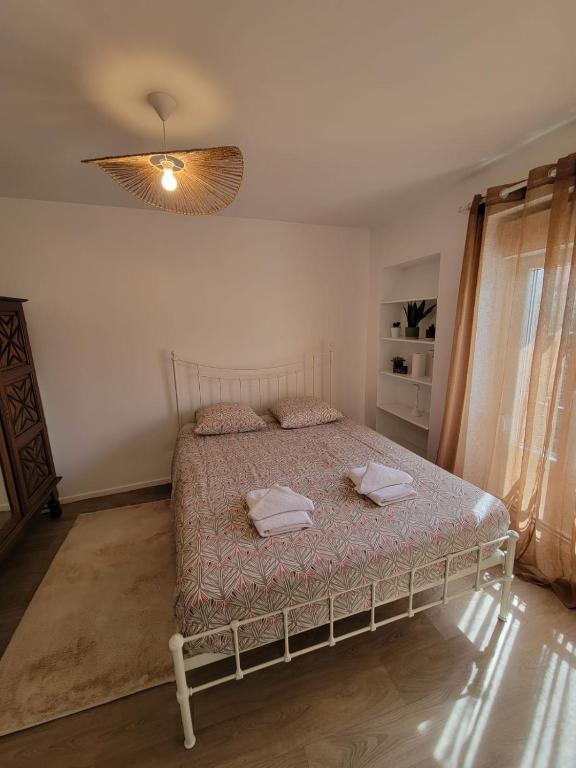 a bedroom with a bed with two towels on it at Bel appartement hyper centre, 3 pièces 60m² in Périgueux