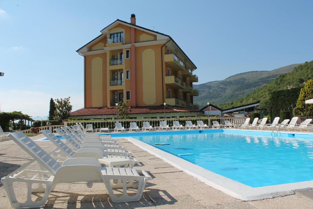 a swimming pool with lounge chairs and a building at FILIPPONE HOTEL&RISTORANTE in Gioia dei Marsi