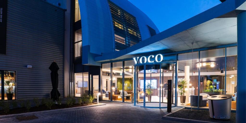 a building with a yoga sign on the side of it at voco Brussels City North, an IHG Hotel in Vilvoorde