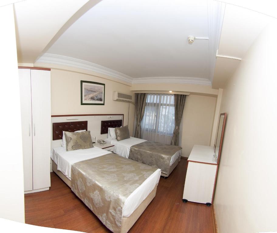 Ліжко або ліжка в номері Tayhan Hotel