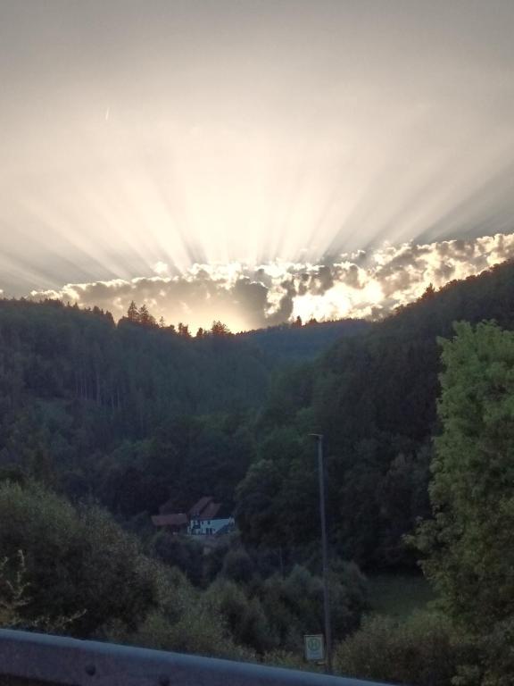 a view of the sun setting over a mountain at Cozy apartment in Eberbach