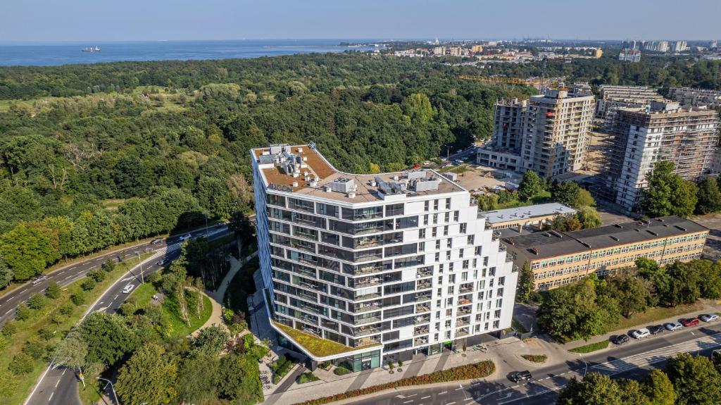 an aerial view of a tall white building at Luxury Tarasy Bałtyku with Stunning Views & Sauna & Gym by Renters Prestige in Gdańsk