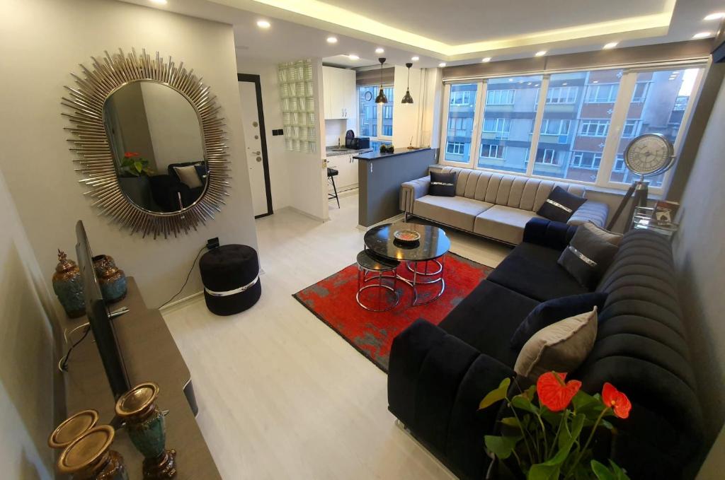 a living room with a couch and a mirror at Calm & Cosy Flat in Perfect Location Nişantaşı in Istanbul