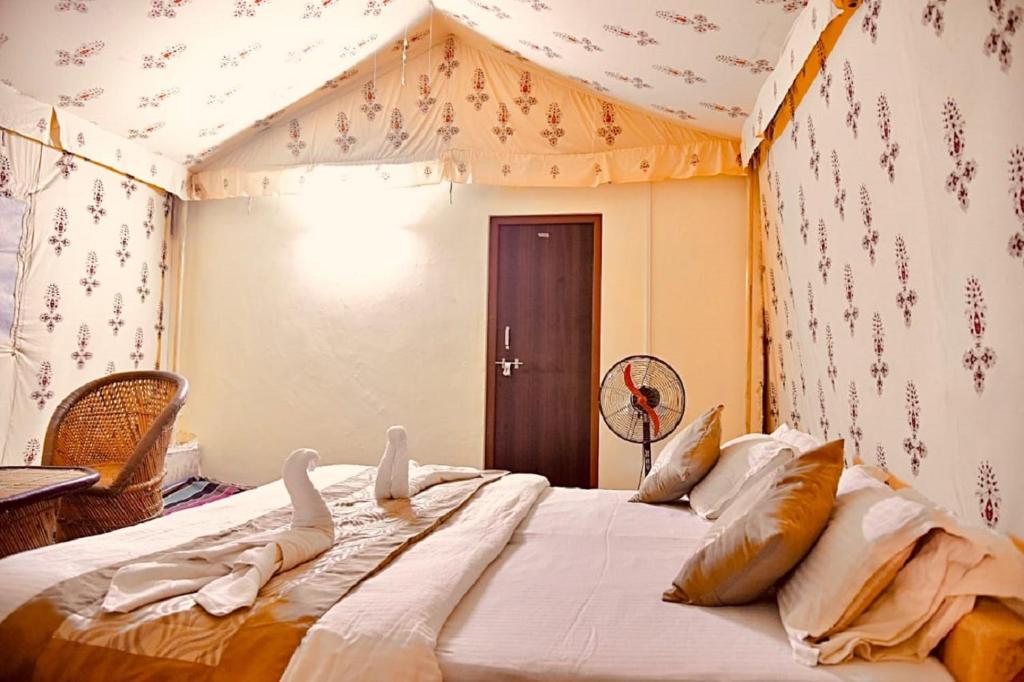 a bedroom with a large bed in a tent at Destination Desert Camp in Jaisalmer