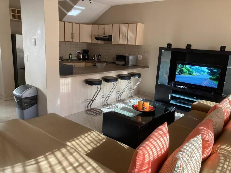 a living room with a couch and a flat screen tv at Praia Da Lagosta in Langstrand