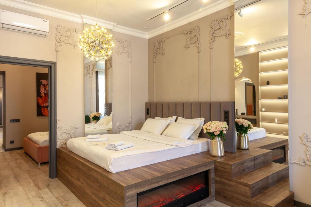 a bedroom with a large bed and a fireplace at Royal apartment on Gorodotska 33 street in Lviv