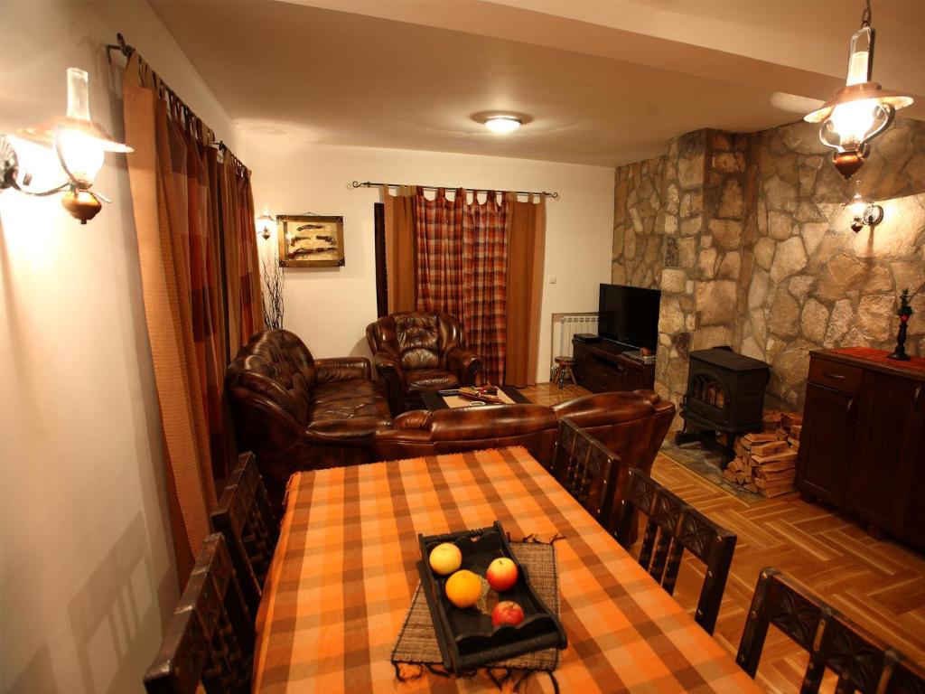 a living room with a table and a couch at Family Apartments in Žabljak