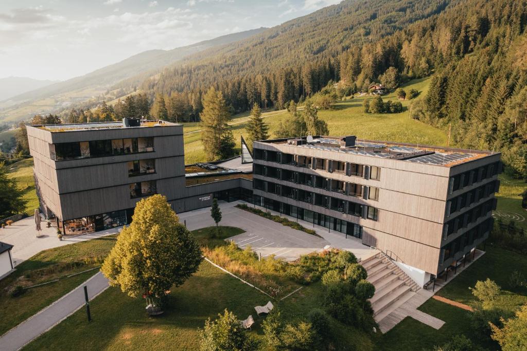 an aerial view of a building with mountains in the background at St Michael Alpin Retreat in Matrei am Brenner