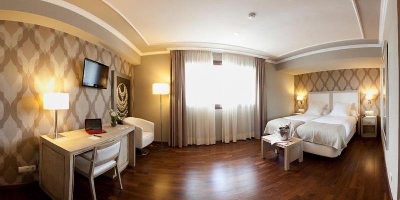 Posteľ alebo postele v izbe v ubytovaní Hotel Os Olivos