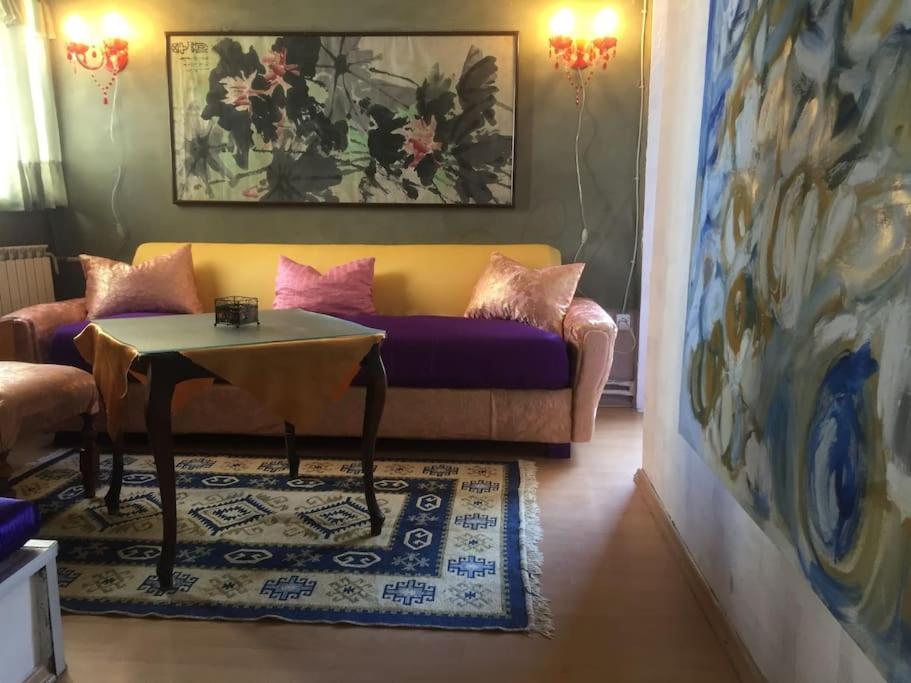 a living room with a couch and a table at Art Gallery Apartment in Skopje