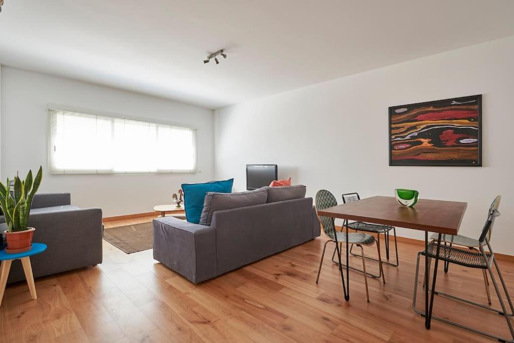 a living room with a couch and a table at Modern apartment in Parque das Nações in Lisbon