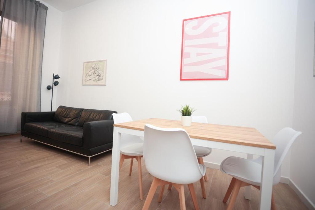 a living room with a table and a couch at Vatican Museum Apartment in Rome