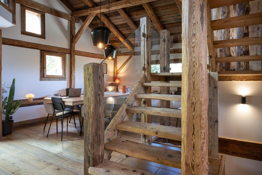 a spiral staircase in a room with a table at Wanderful Life MontBlanc refuge haut de gamme in Saint-Gervais-les-Bains