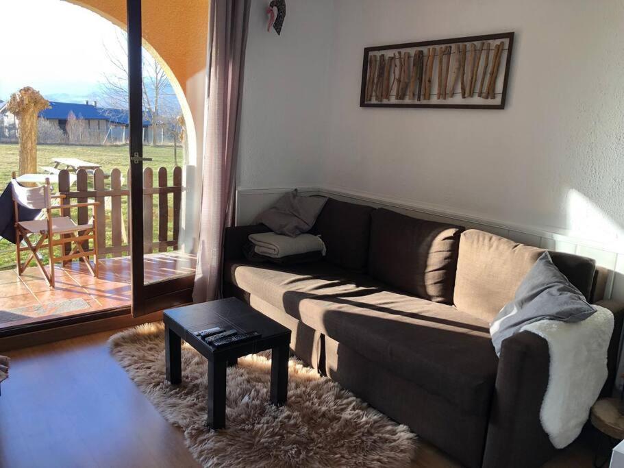 a living room with a couch and a table at Bleuets II in Sainte-Léocadie