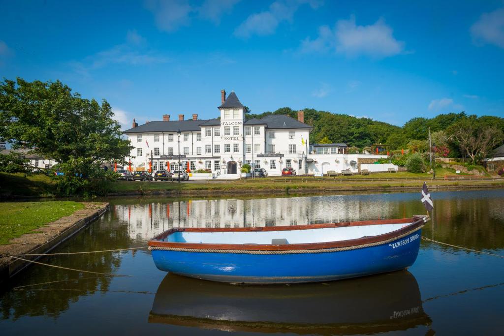 a blue boat in the water in front of a building at The Falcon Hotel in Bude