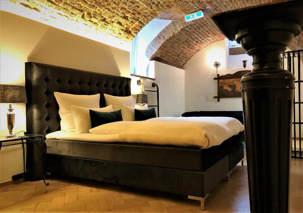 Historical Luxury Homes - Luxus Suite Colloseum في فريبورغ ام بريسغاو: غرفة نوم مع سرير كبير مع اللوح الأمامي الأسود