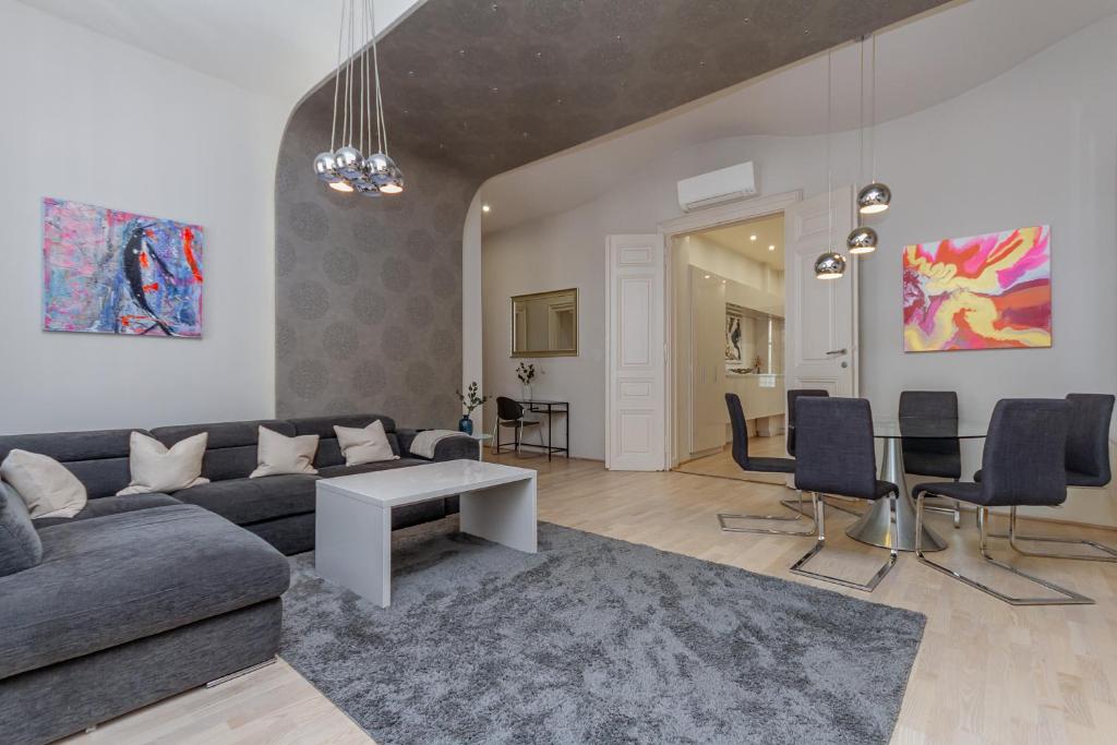 a living room with a couch and a table at Andrássy Str. Luxury Apartment in Budapest