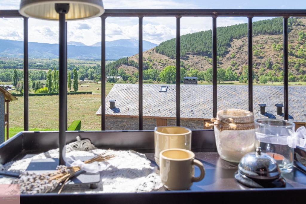 a kitchen counter with a view of a lake and mountains at Apartament les Carrerades in Estavar