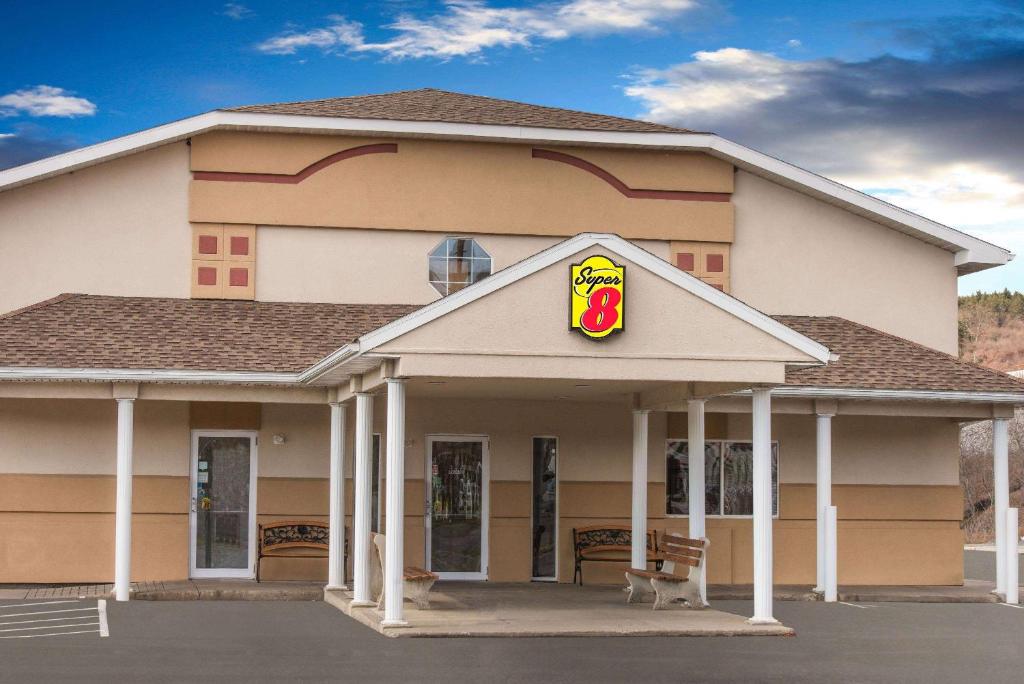 a fast food building with a pdonalds sign on it at Super 8 by Wyndham Clearfield in Clearfield