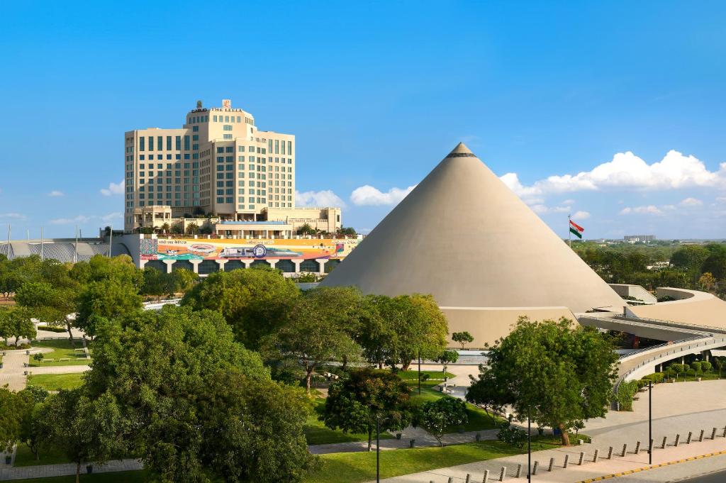 a view of the pyramids of the louvre and buildings at The Leela Gandhinagar in Gandhinagar