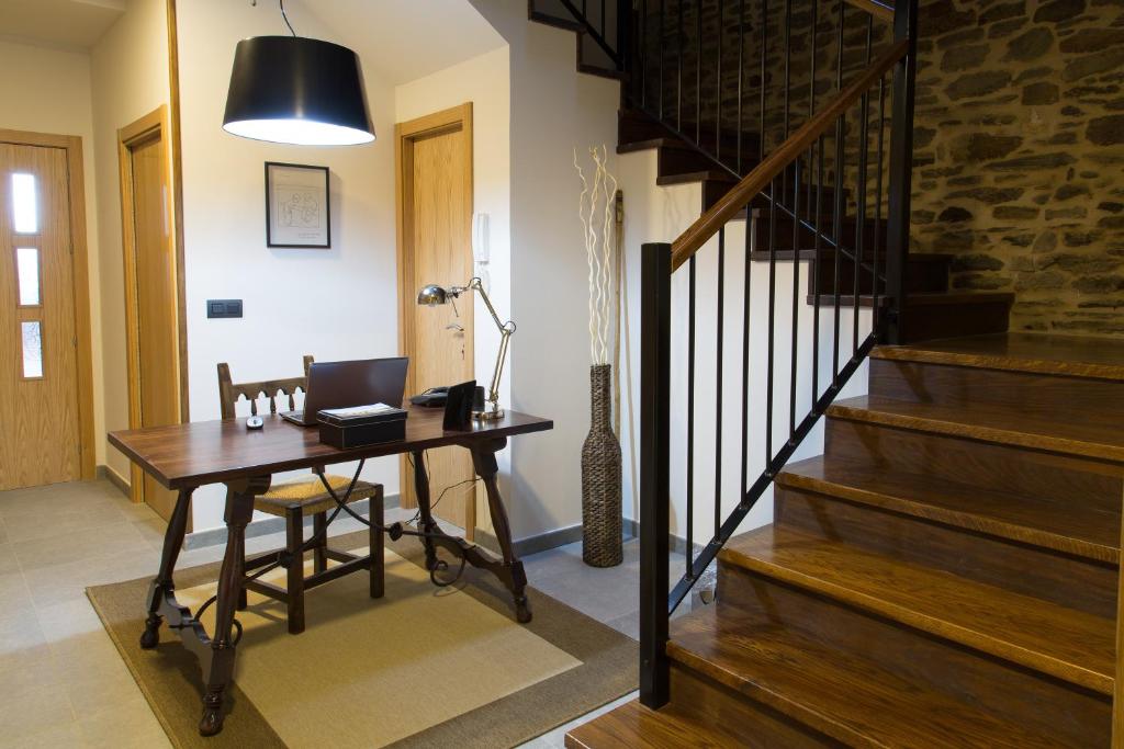 a home office with a desk and a laptop at Casa Baran in Sarria