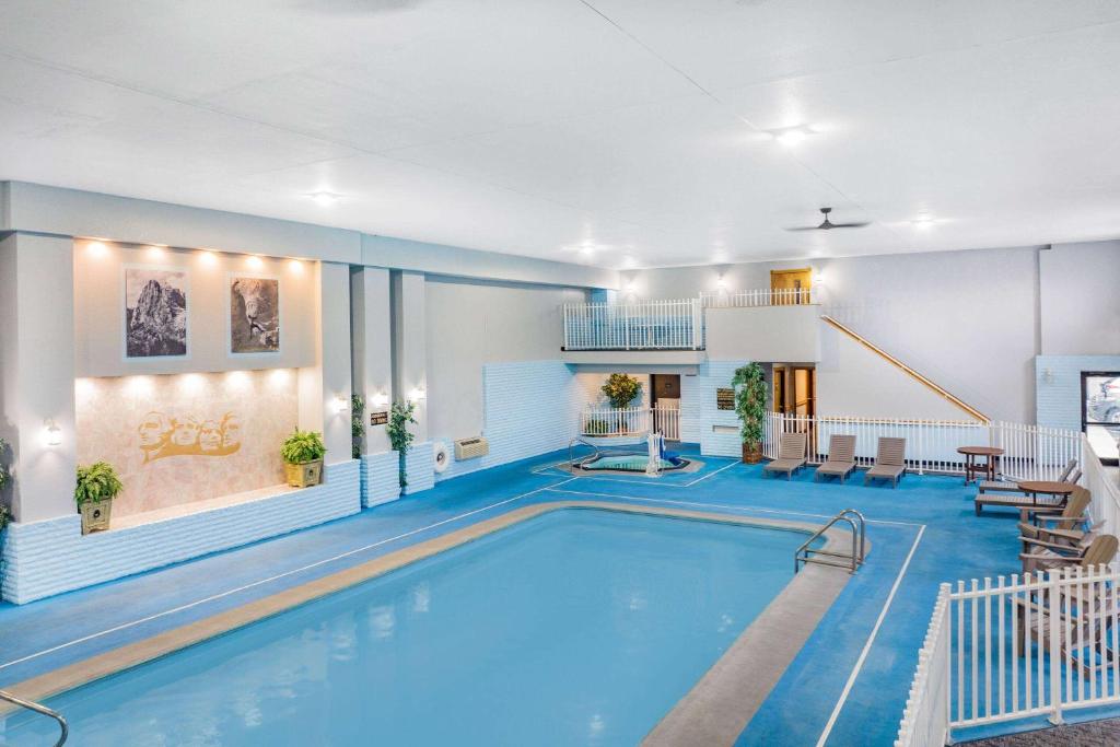 a pool in a hotel room with a swimming pool at Baymont by Wyndham Keystone Near Mt. Rushmore in Keystone