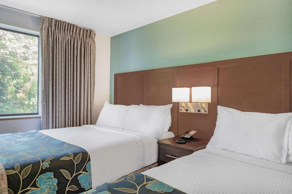 a hotel room with two beds and a window at Baymont by Wyndham Keystone Near Mt. Rushmore in Keystone