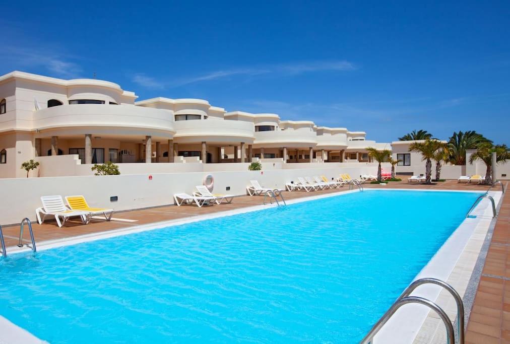 a swimming pool in front of a resort at Riviera Park 2b, central 2 bed in Puerto del Carmen