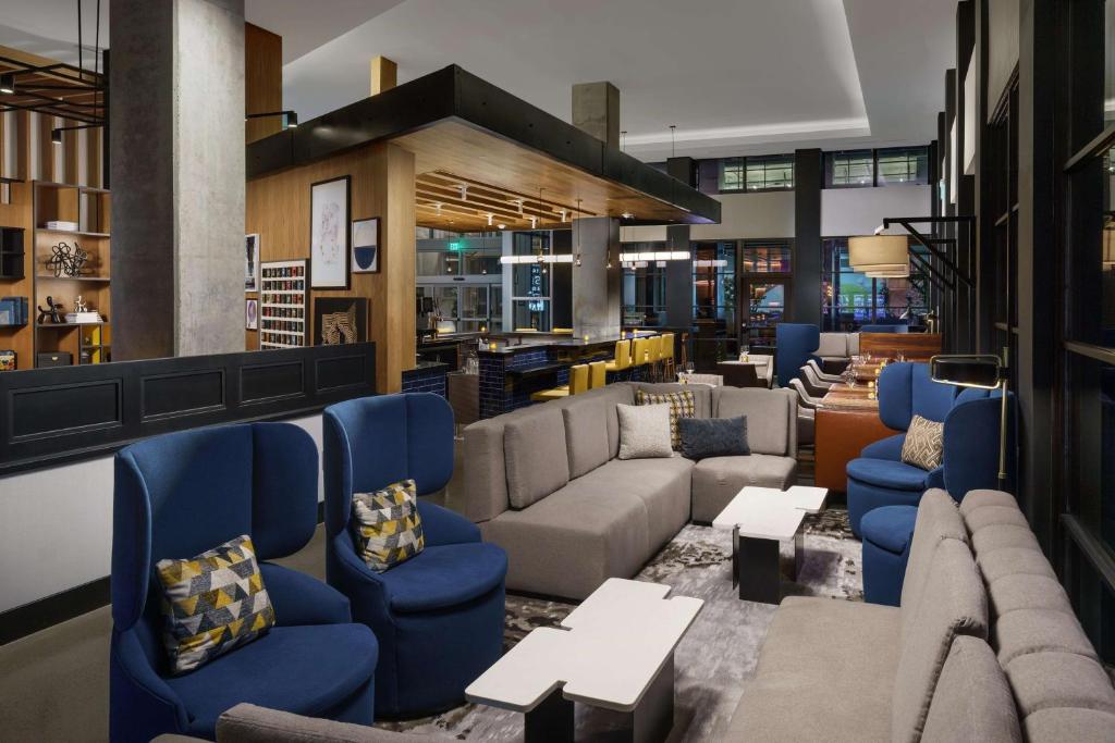 a lobby with couches and couches and tables at Hyatt Centric Mountain View in Mountain View