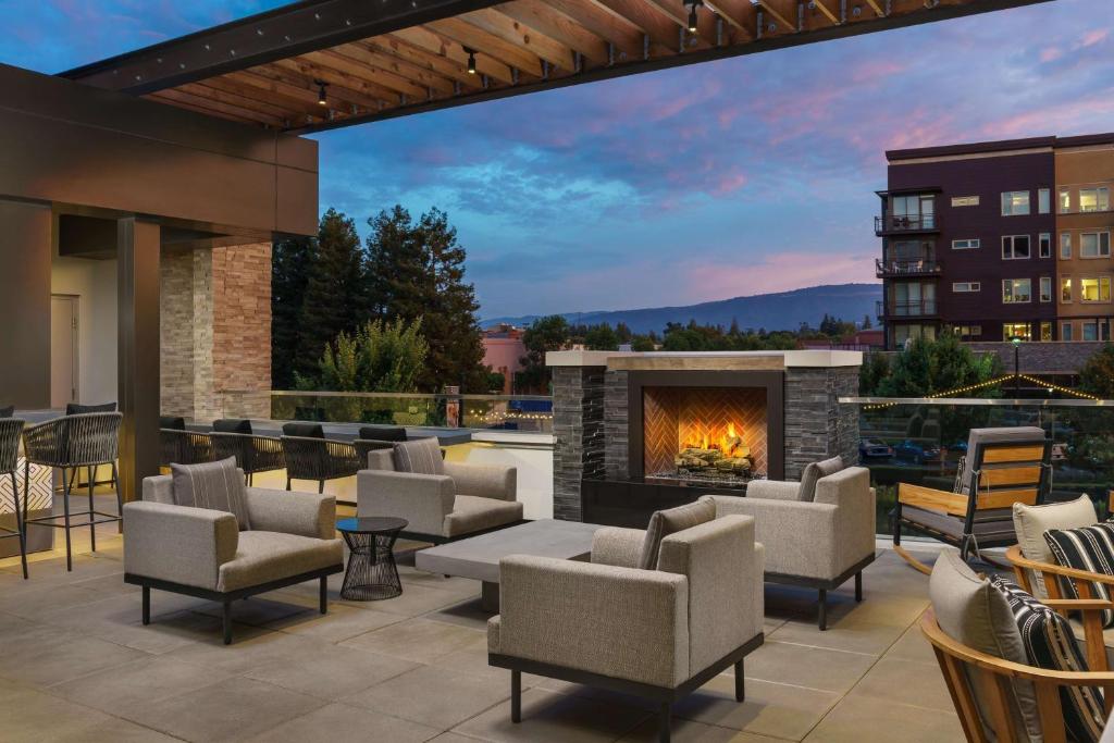 an outdoor patio with chairs and a fireplace at Hyatt Centric Mountain View in Mountain View