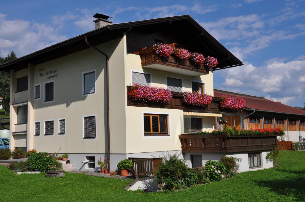 a white building with flower boxes on it at Ferienhaus Mattersberger in Oberlienz