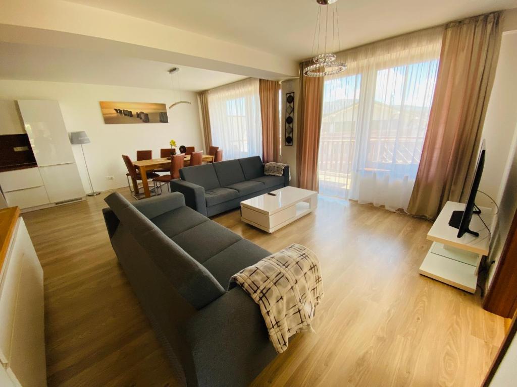 a living room with a couch and a table at Apartmán Donovaly, Panorama in Donovaly