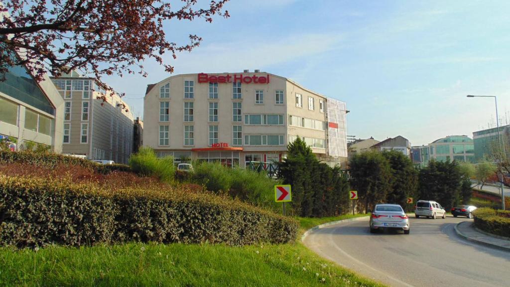 a car driving down a road in front of a building at BEST HOTEL BURSA in Bursa