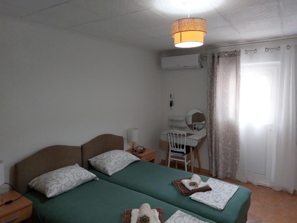 a bedroom with two beds and a table and a window at Vicky Apartments in Kotor