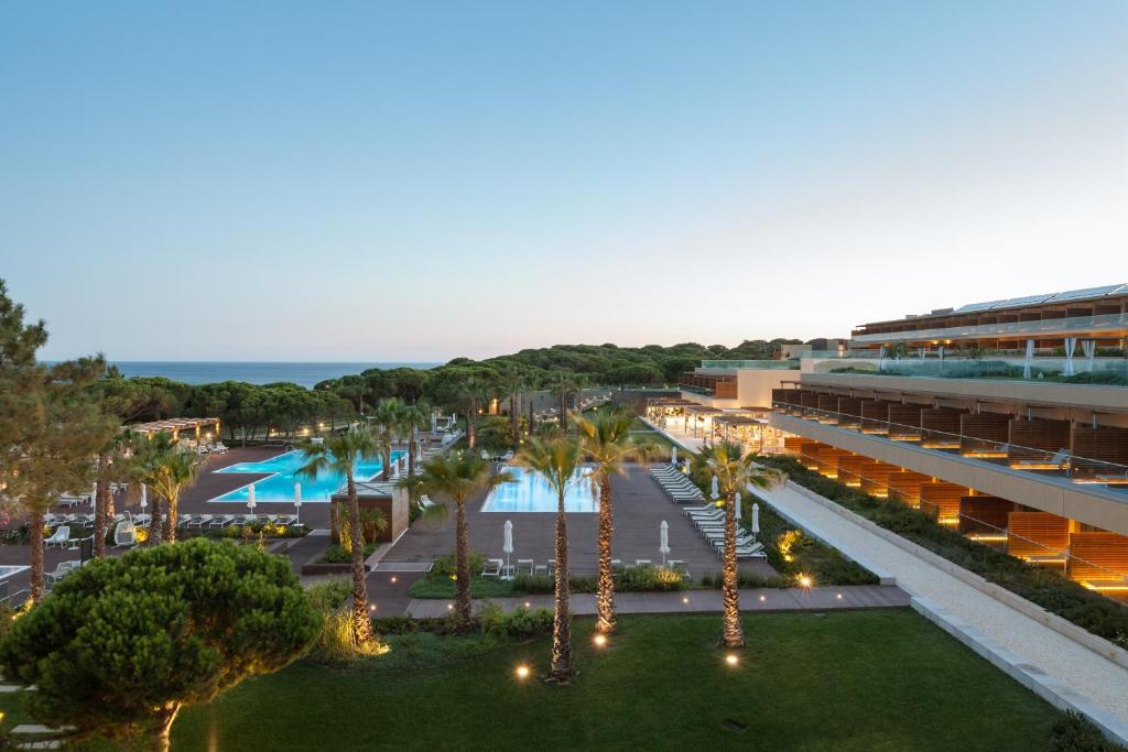 an aerial view of a resort with palm trees and a pool at EPIC SANA Algarve Hotel in Albufeira