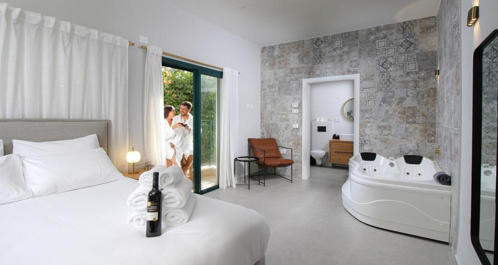 a hotel room with a bed and a bath tub at 49 Boutique in Zikhron Ya‘aqov