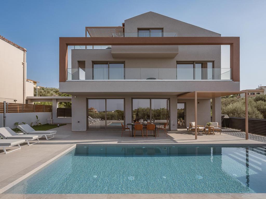 a house with a swimming pool in front of a house at Estel Residences in Chania Town