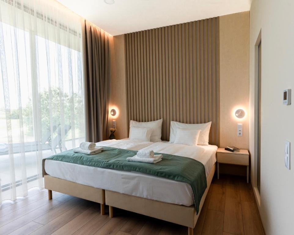A bed or beds in a room at Zala Springs Golf Resort