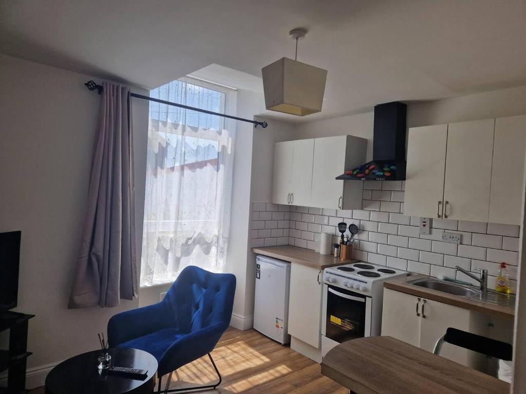 una cocina con mesa y sillas azules. en Beautiful 1-Bed Apartment in Cork, en Cork