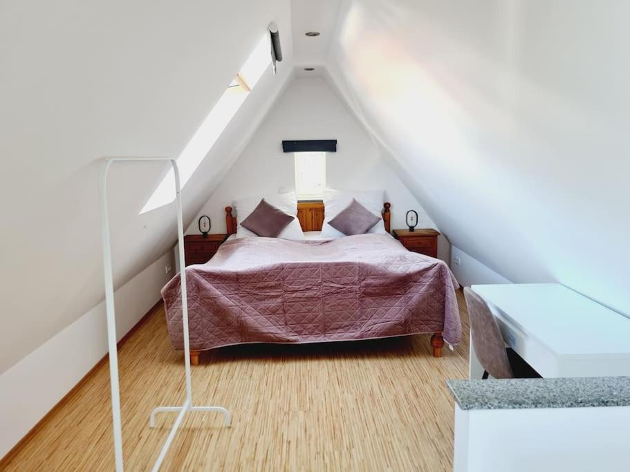 a bedroom with a bed in a attic at Theox No 13 - 6 Pers - Senseo in Heppenheim an der Bergstrasse