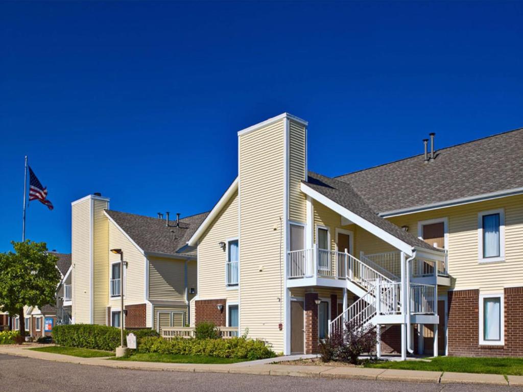 a row of houses on a street with an american flag at Sonesta ES Suites Colorado Springs in Colorado Springs