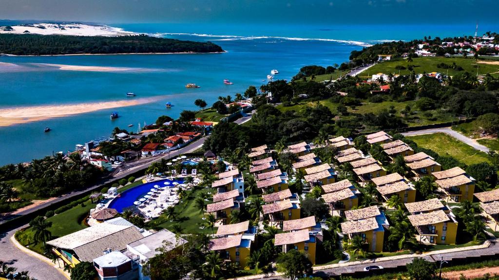 een luchtzicht op een resort naast een waterlichaam bij Pipa Lagoa Hotel in Pipa